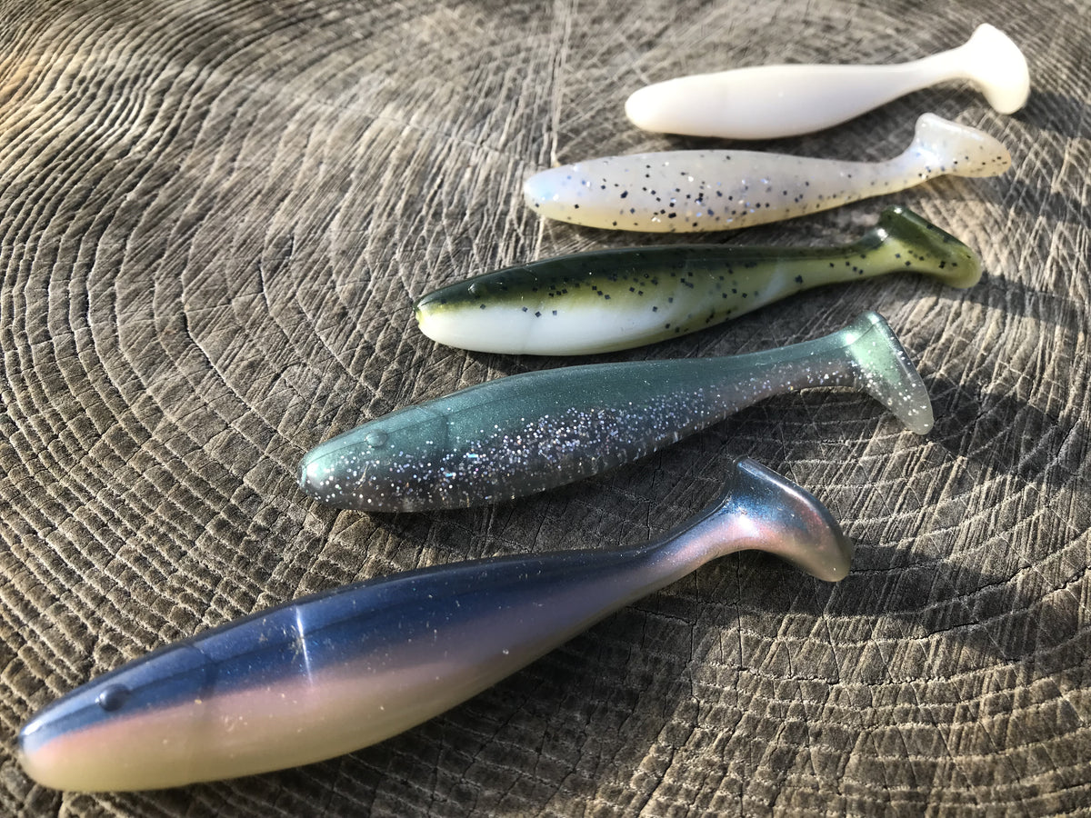 Swimbait lures displayed on wooden background